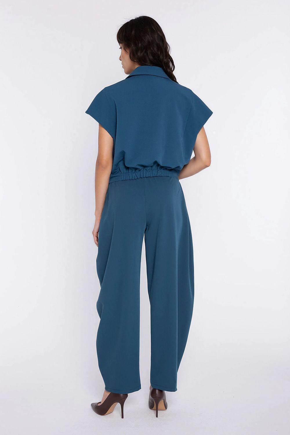 Women’s trousers by Nife in teal blue, elastic waist, wide-leg silhouette, back view