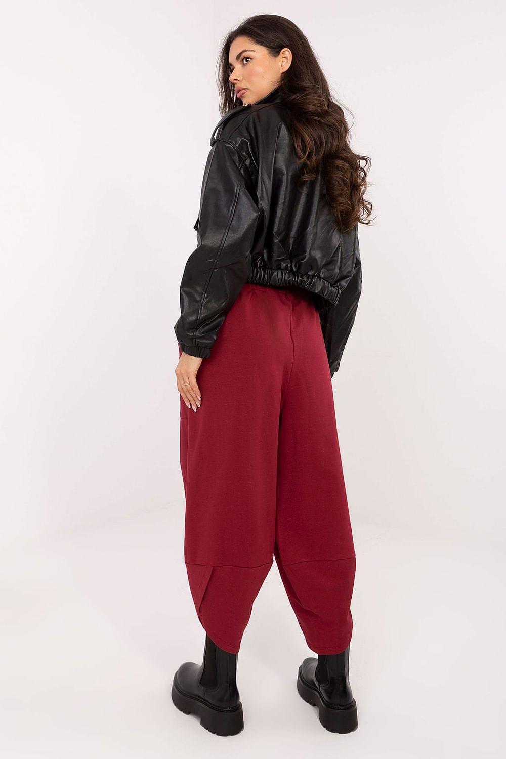 Burgundy track trousers with elastic waist and tapered leg with cuffed hem
