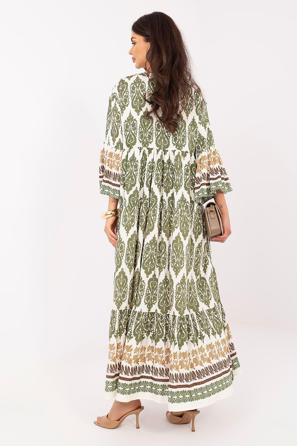 Green patterned daydress shown from back, long flared sleeves and tiered hem trim