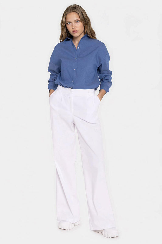 White wide-leg jeans with button closure and relaxed straight legs