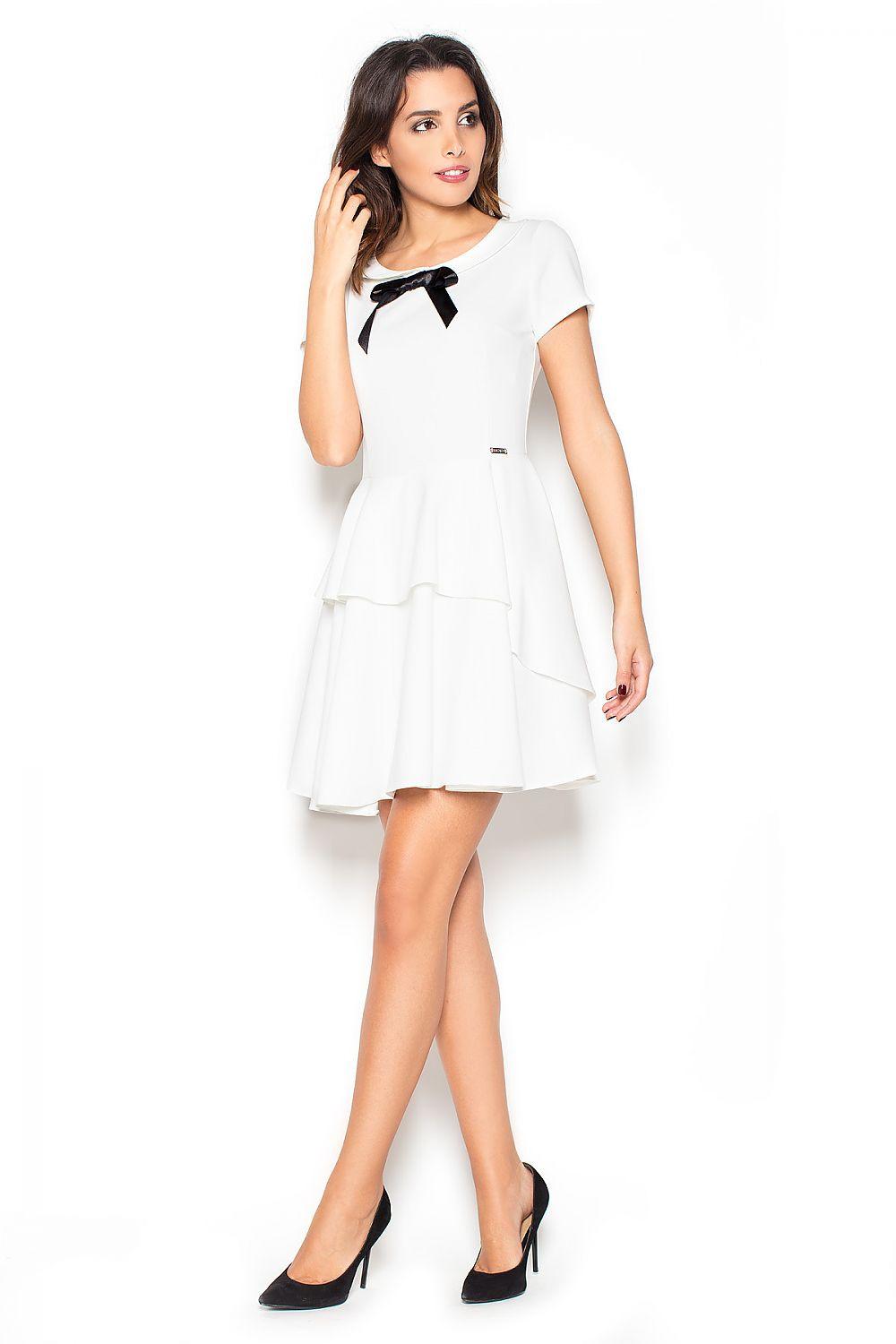 White day dress with black bow neckline, short sleeves, tiered ruffle skirt