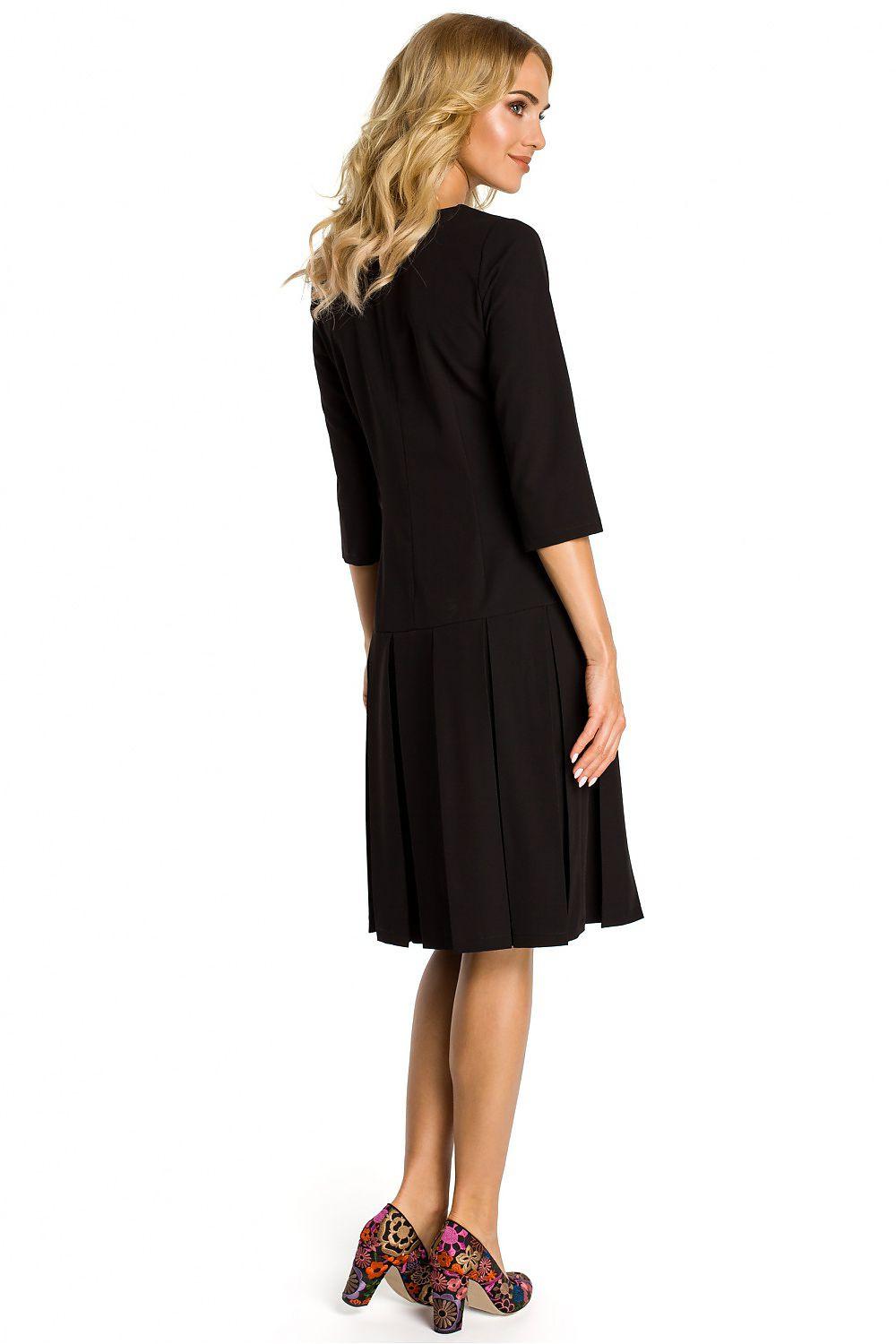 Black daydress back view with 3/4 sleeves and pleated hem