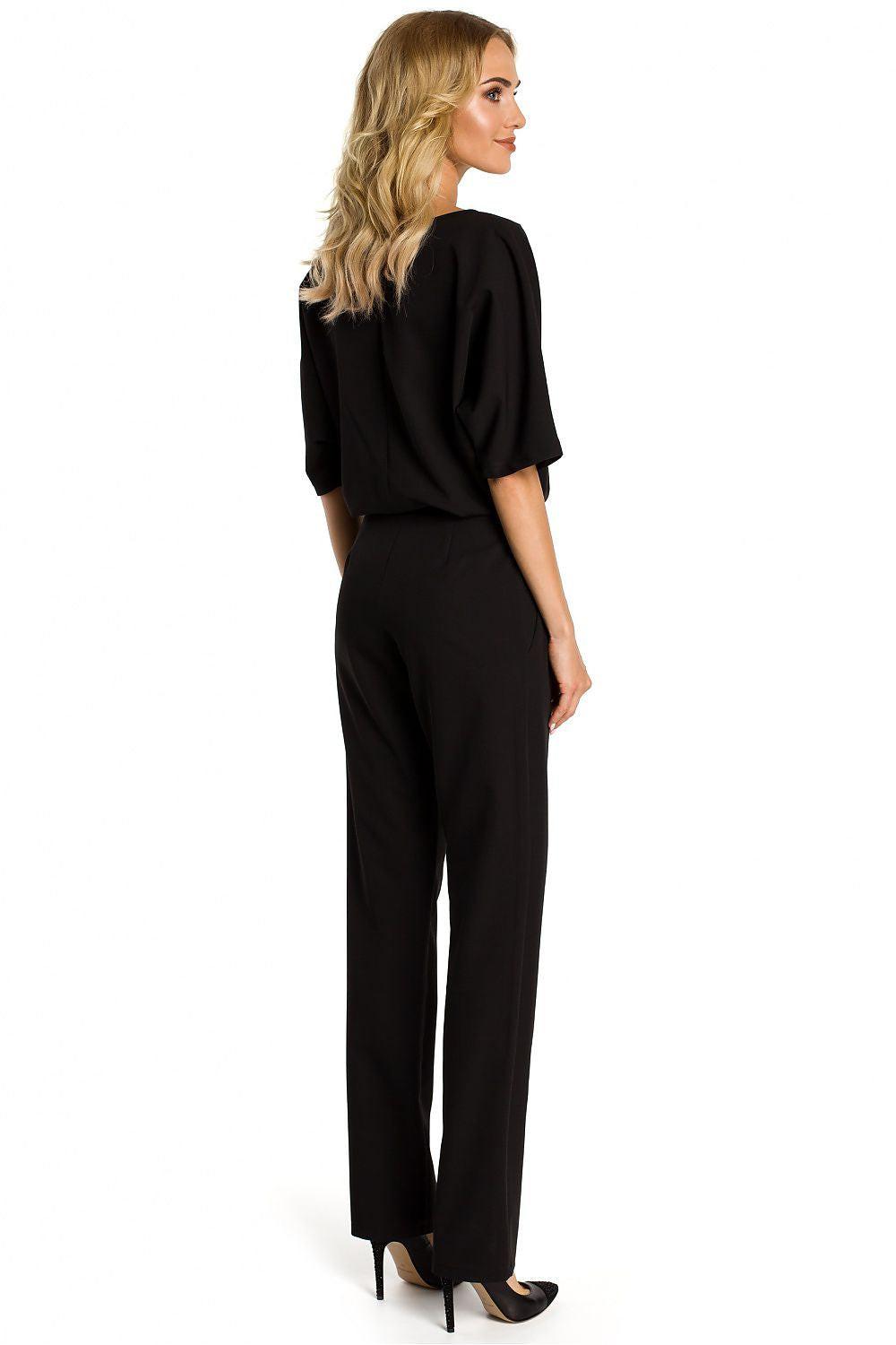 Moe Suit model 107537 black V-neck blouse and tied straight-leg trousers, side view