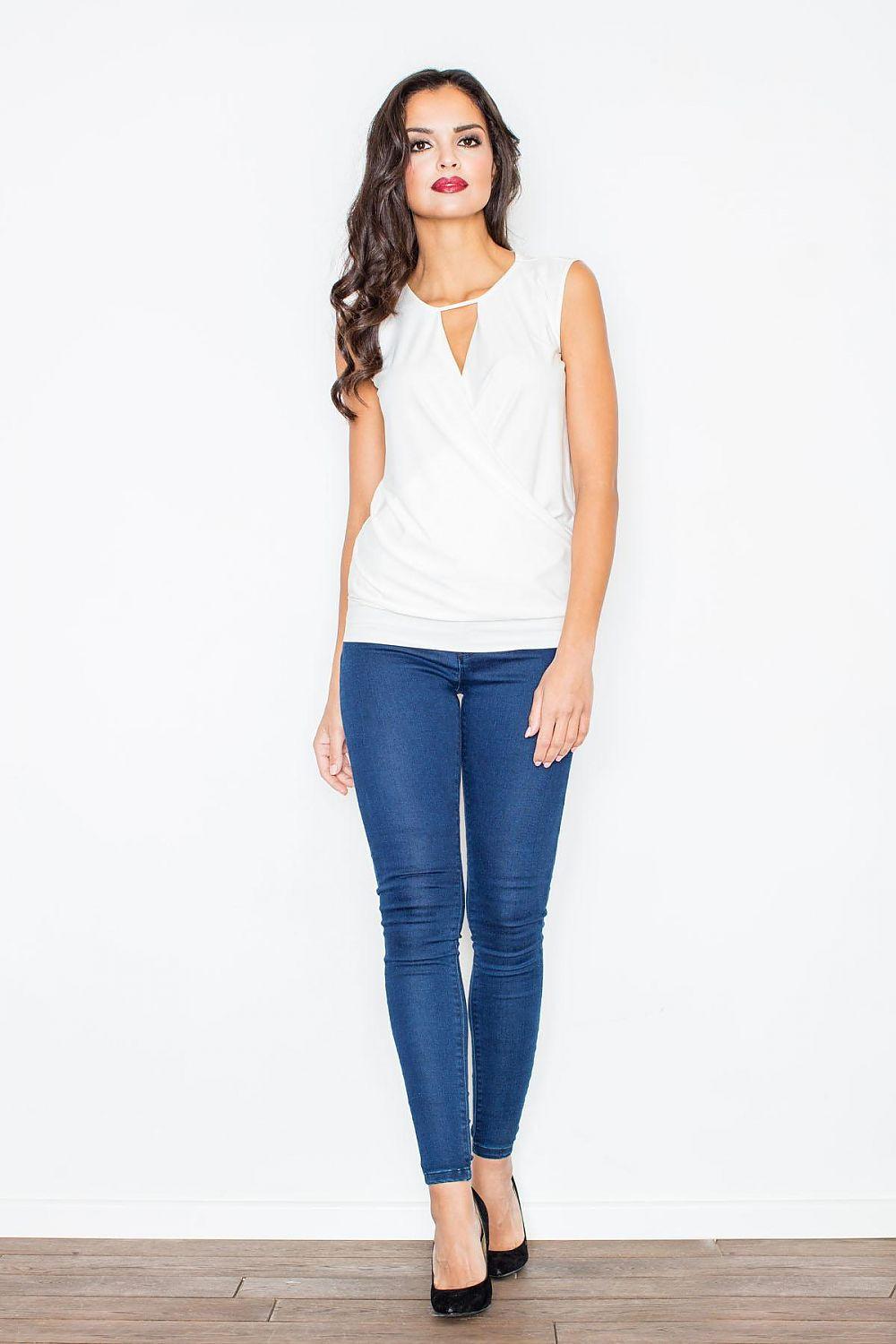 White sleeveless blouse with V-neck cutout and wrap front, standing full view