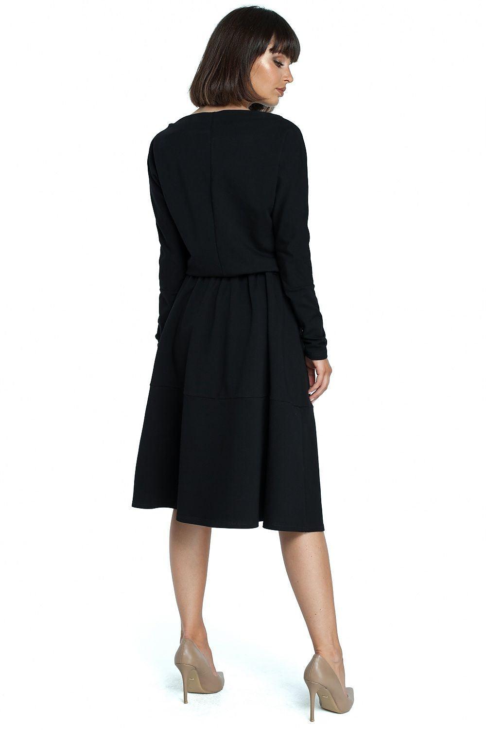 Black daydress back view with long sleeves and gathered waist, midi length
