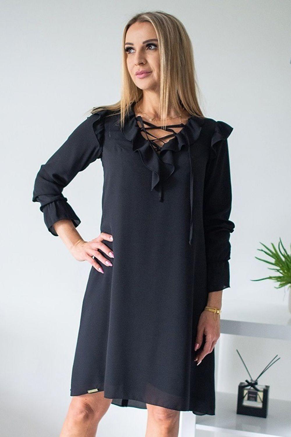 Black evening dress with long sleeves and layered ruffle detailing at shoulders and cuffs.