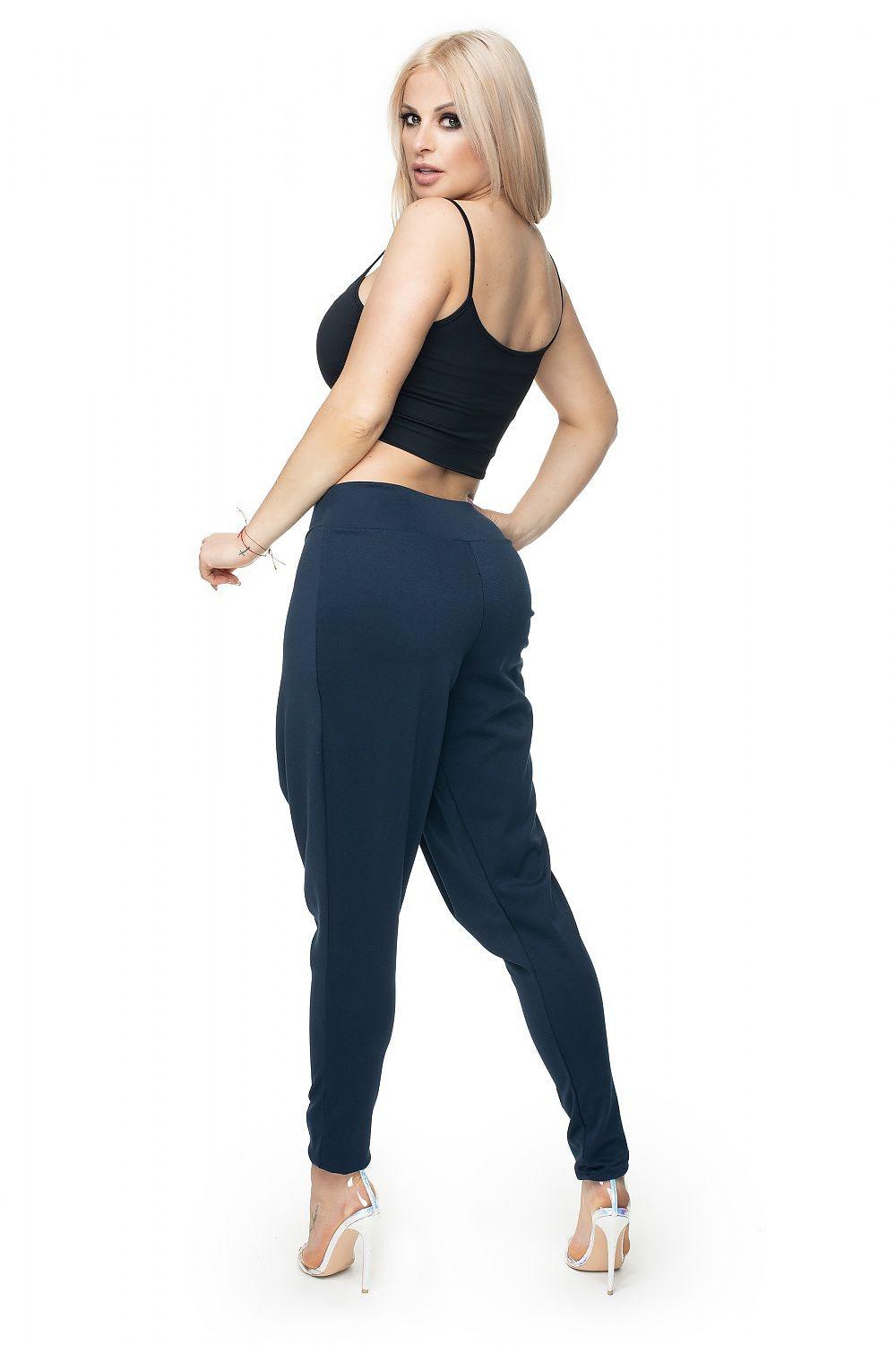 Navy blue tapered trousers with wrap-front drape and ankle-length legs