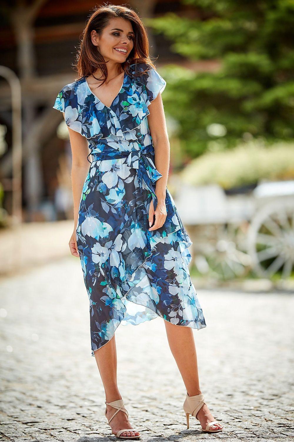 Navy blue floral cocktail dress with ruffled cap sleeves, waist tie, and layered midi hem