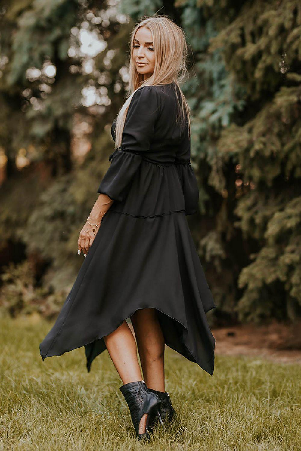 Black daydress with long sleeves, gathered waist, and asymmetrical tiered skirt