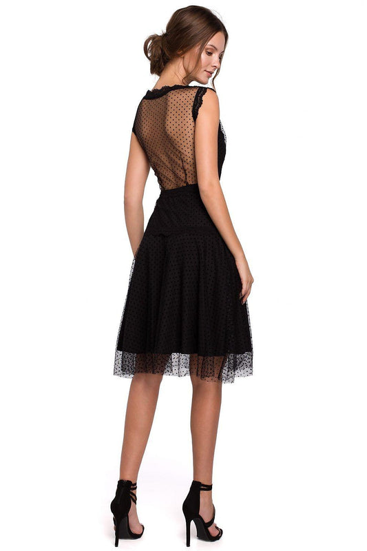 Back view black sleeveless cocktail dress with mesh panel and tulle hem