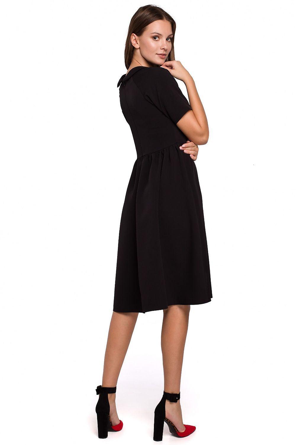 Black short-sleeve daydress with gathered waist and flared hem, side/back view