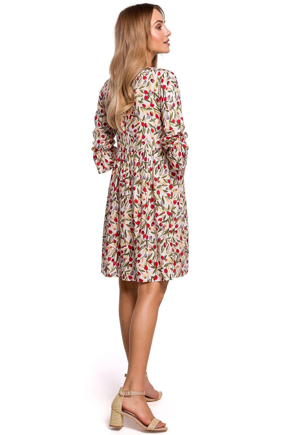 White above-knee daydress with red and green leaf print, long sleeves, side view