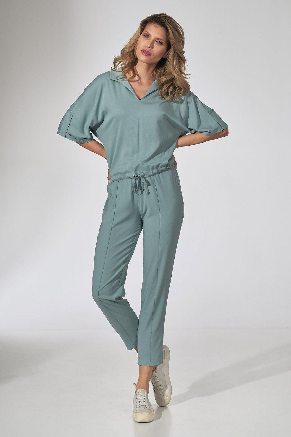 Green V-neck blouse with short sleeves and gathered waist, ankle-length pants