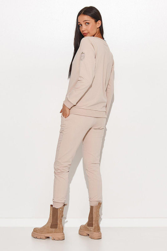 Beige two-piece set with long-sleeve sweatshirt and tapered jogger pants.