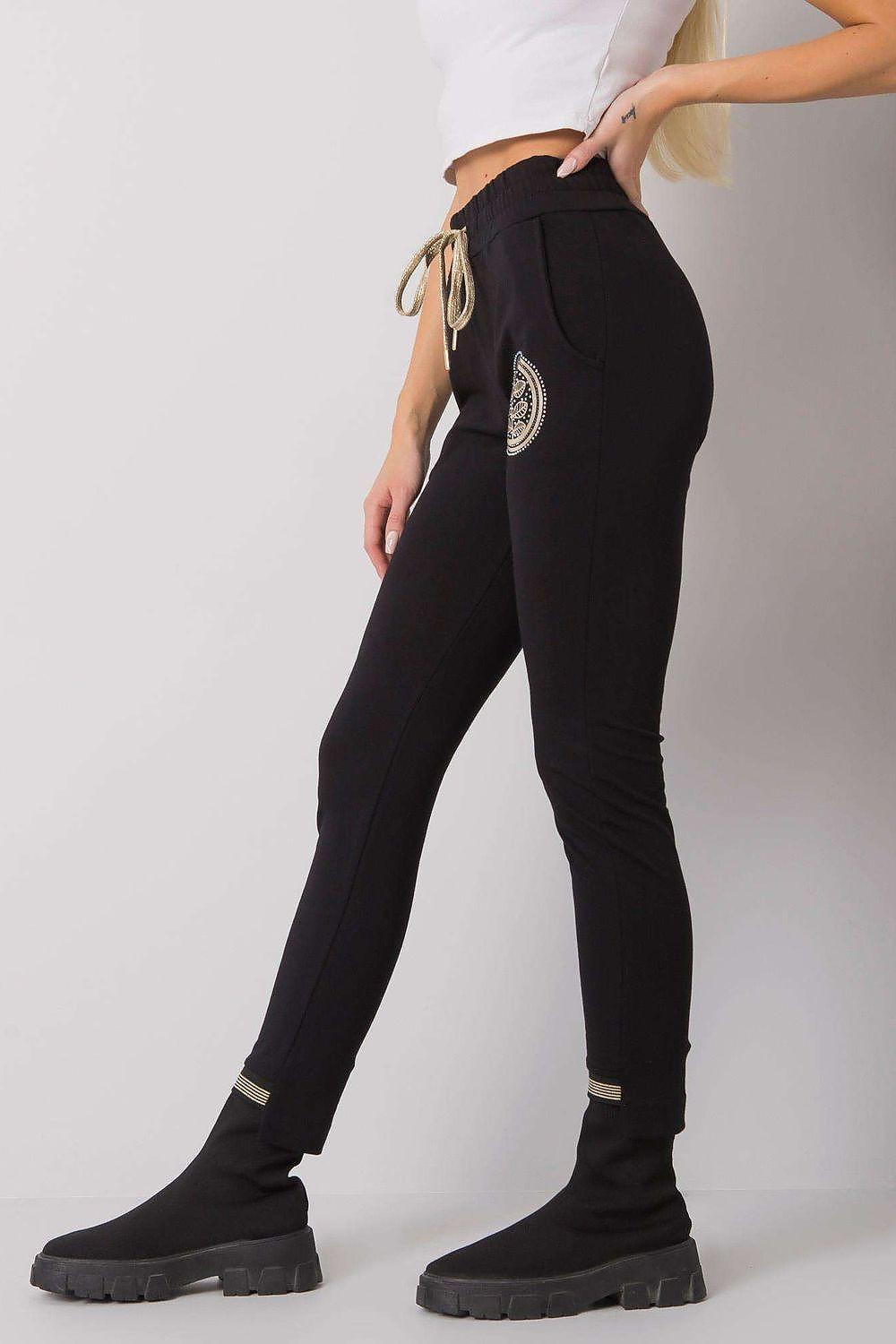 Black tracksuit trousers with drawstring waist, side logo patch, tapered ankle cuffs