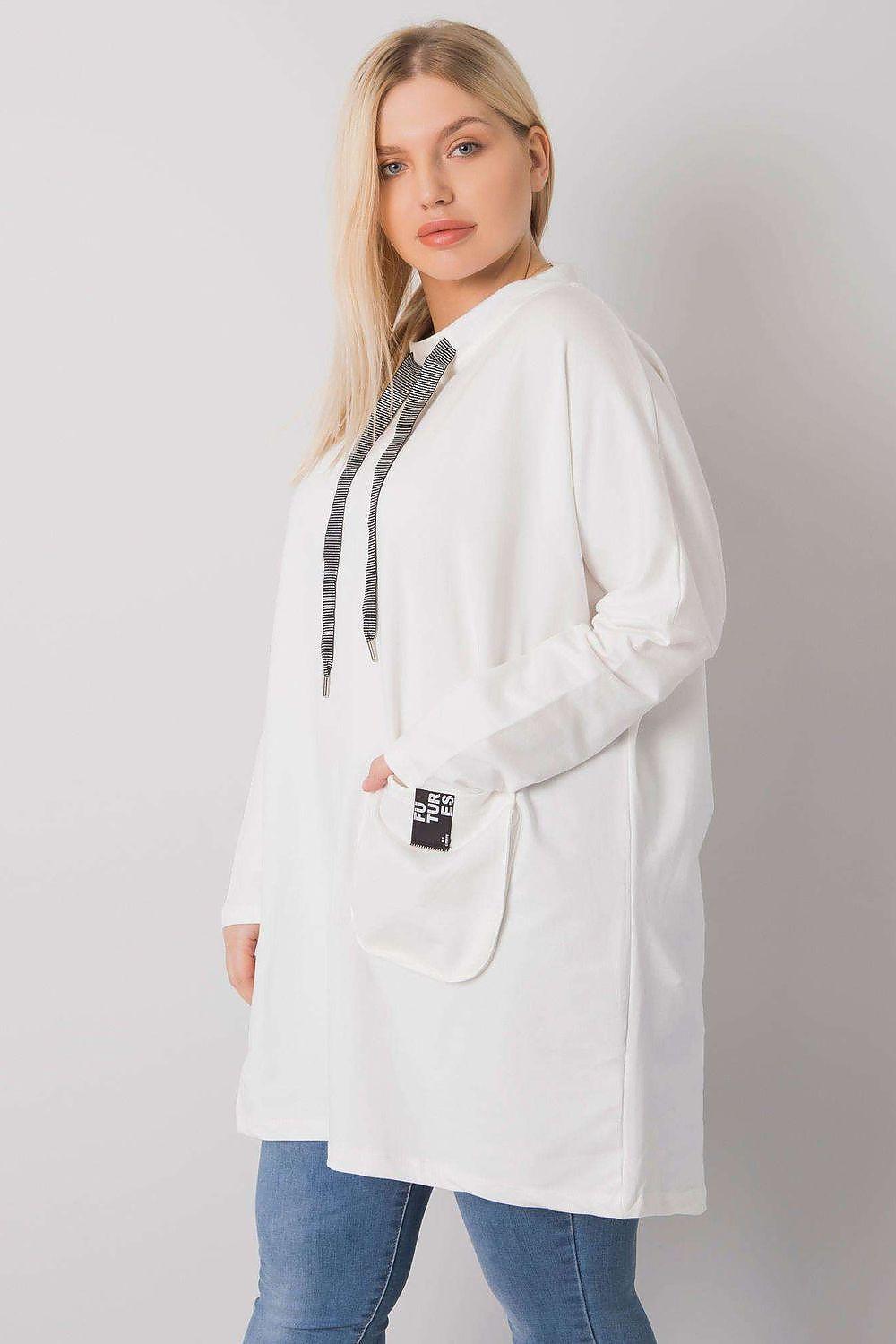 Relevance tunic with long sleeves, front drawstring tassels, and patch pocket