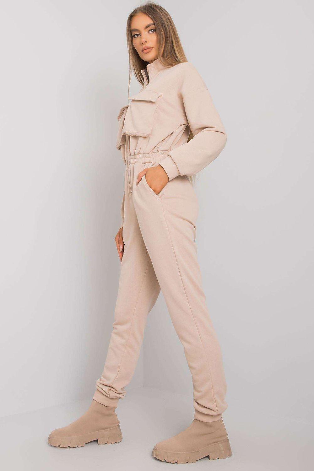 Beige zip-up hooded jumpsuit, side view with tapered legs and elastic cuffs