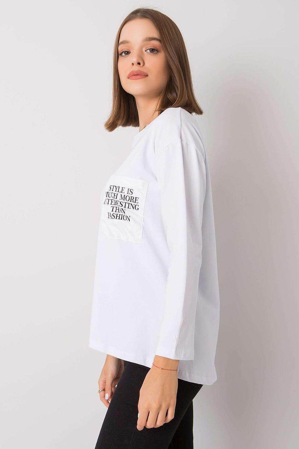 White long-sleeve blouse with crew neck, side view, and front slogan print