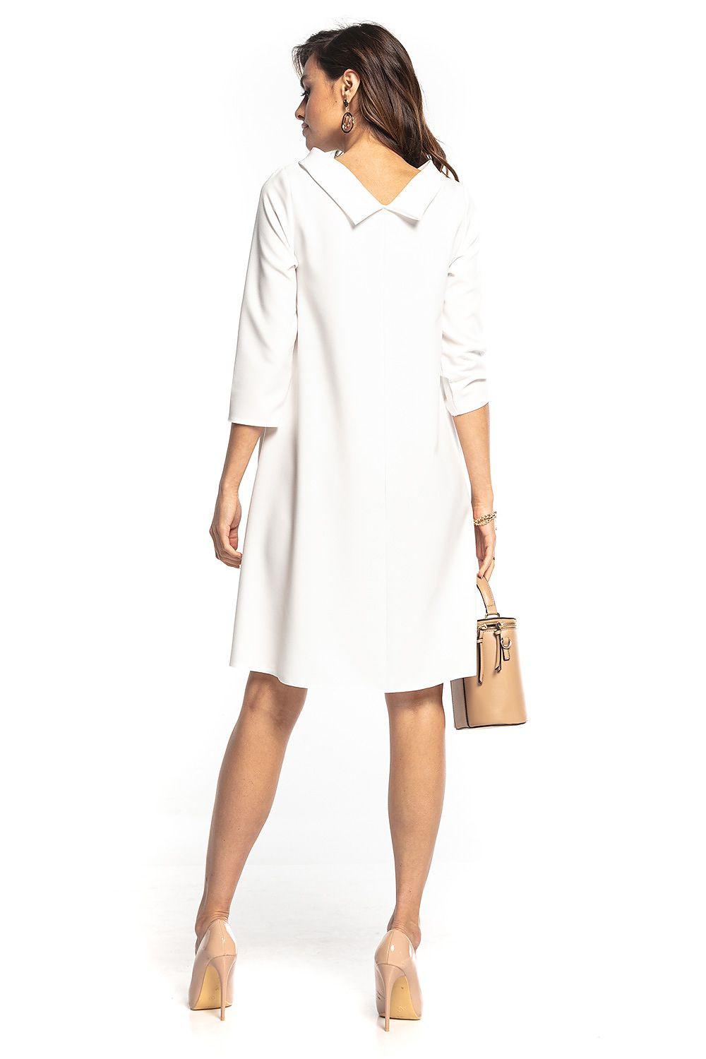 White daydress with pointed collar and elbow-length sleeves, side view