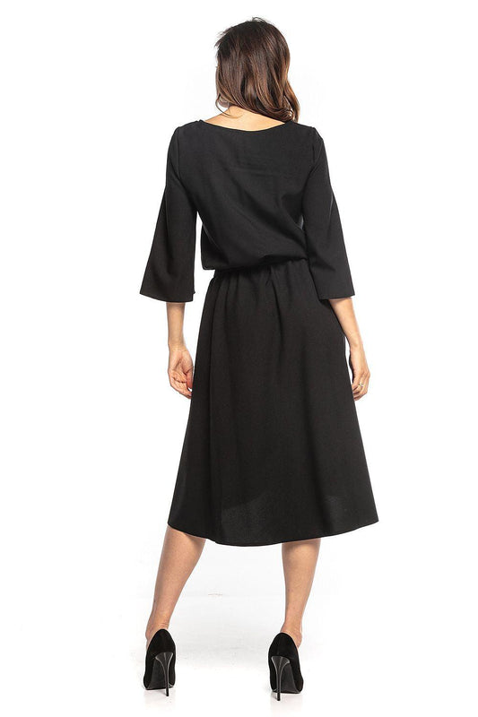 Black day dress back view with gathered waist and 3/4 sleeves, midi A-line skirt.