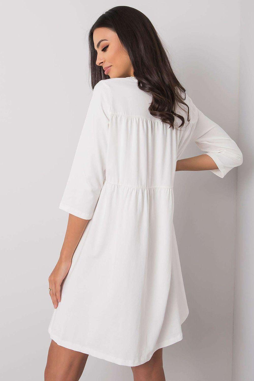 White daydress with 3/4 sleeves and gathered tiered back, knee-length.