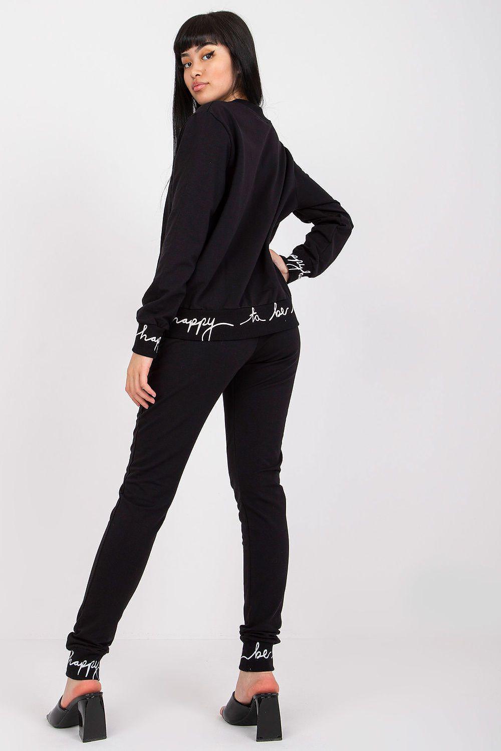 Black hoodie and jogger set, full-body side pose with zipper hoodie and ankle cuffs