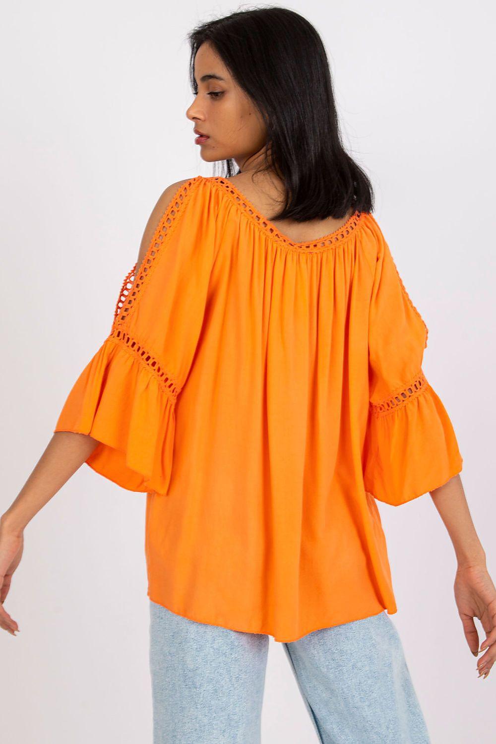 Orange peasant blouse with flared sleeves, embroidered eyelet bands, back/side view