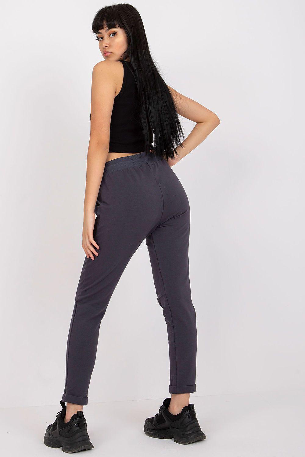 Navy tracksuit trousers with drawstring waist and tapered legs, ankle cuffs