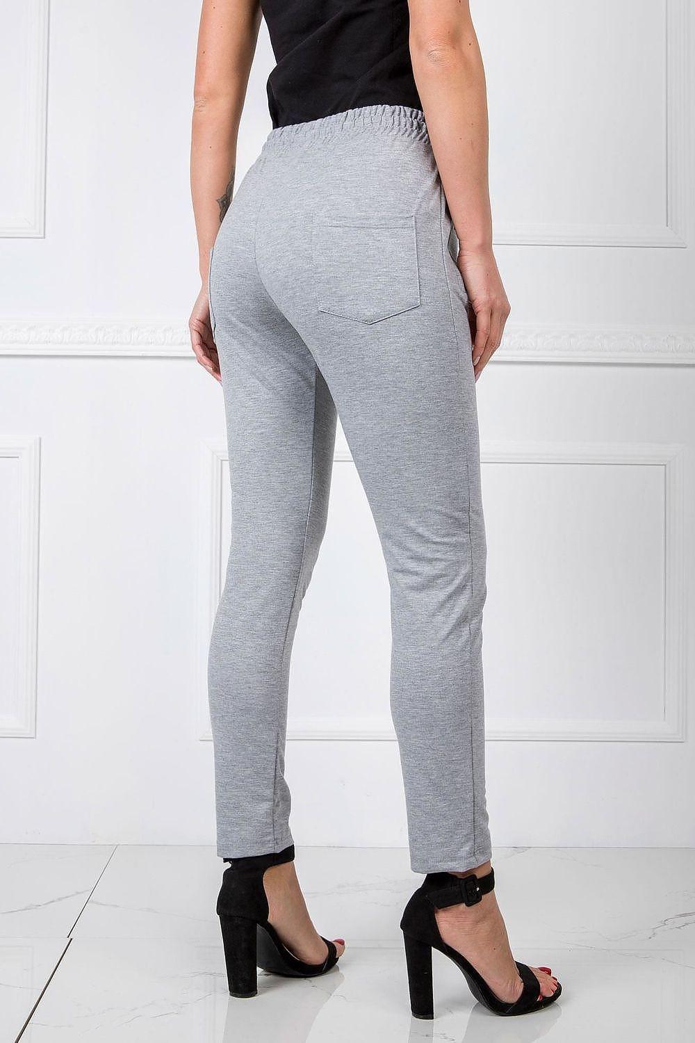 Grey track trousers with back pocket, elastic ankle cuffs and tapered leg shape