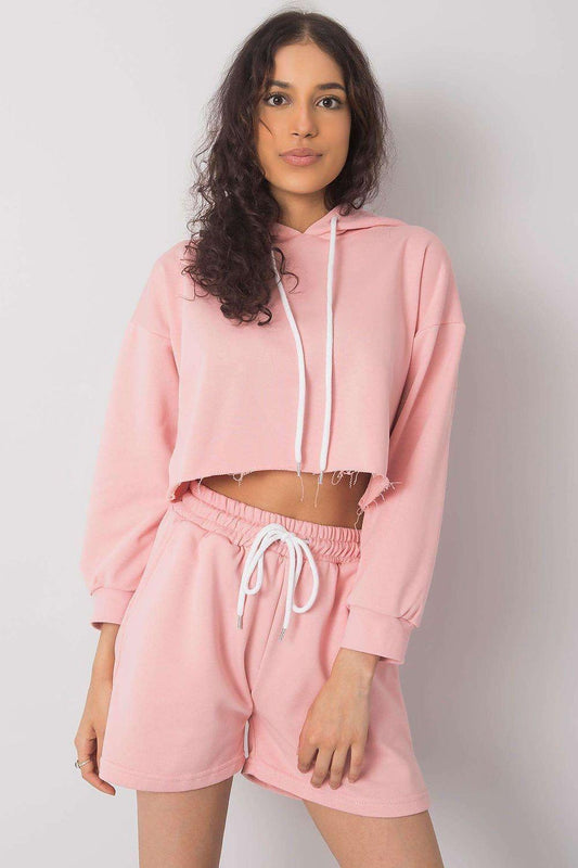 Pink cropped hoodie with hood and white drawstrings, paired with drawstring shorts