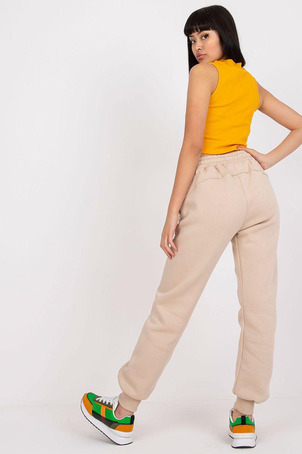 Beige tracksuit trousers with tapered legs, elastic waistband and cuffed hem