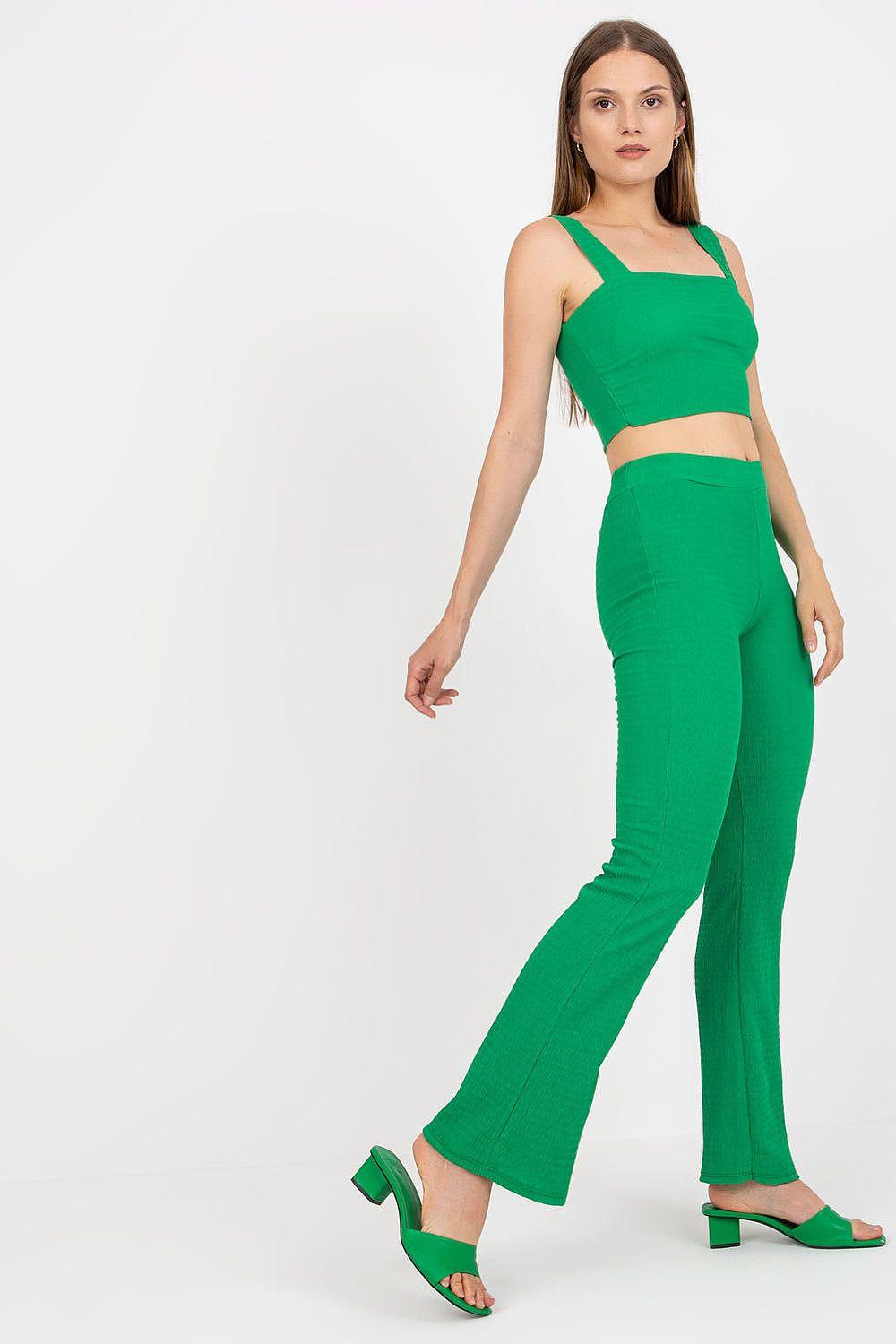 Green sleeveless crop top and matching wide-leg pants set, walking stance