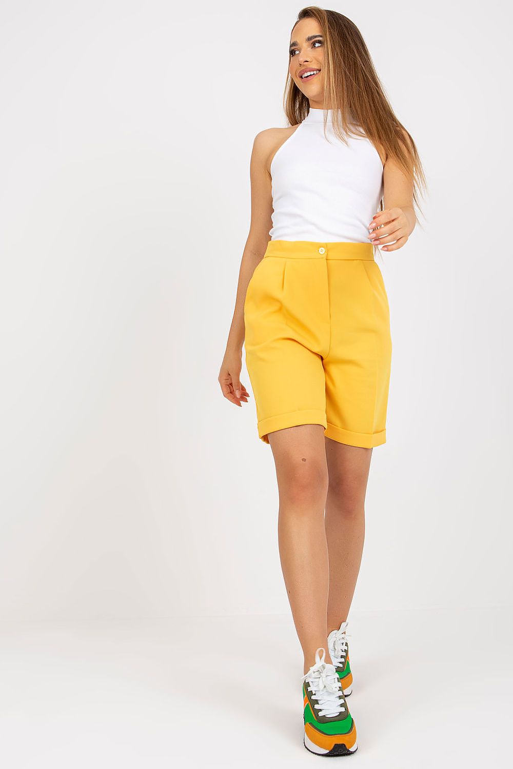 Yellow high-waisted shorts with turned-up hem, fitted waist and front button