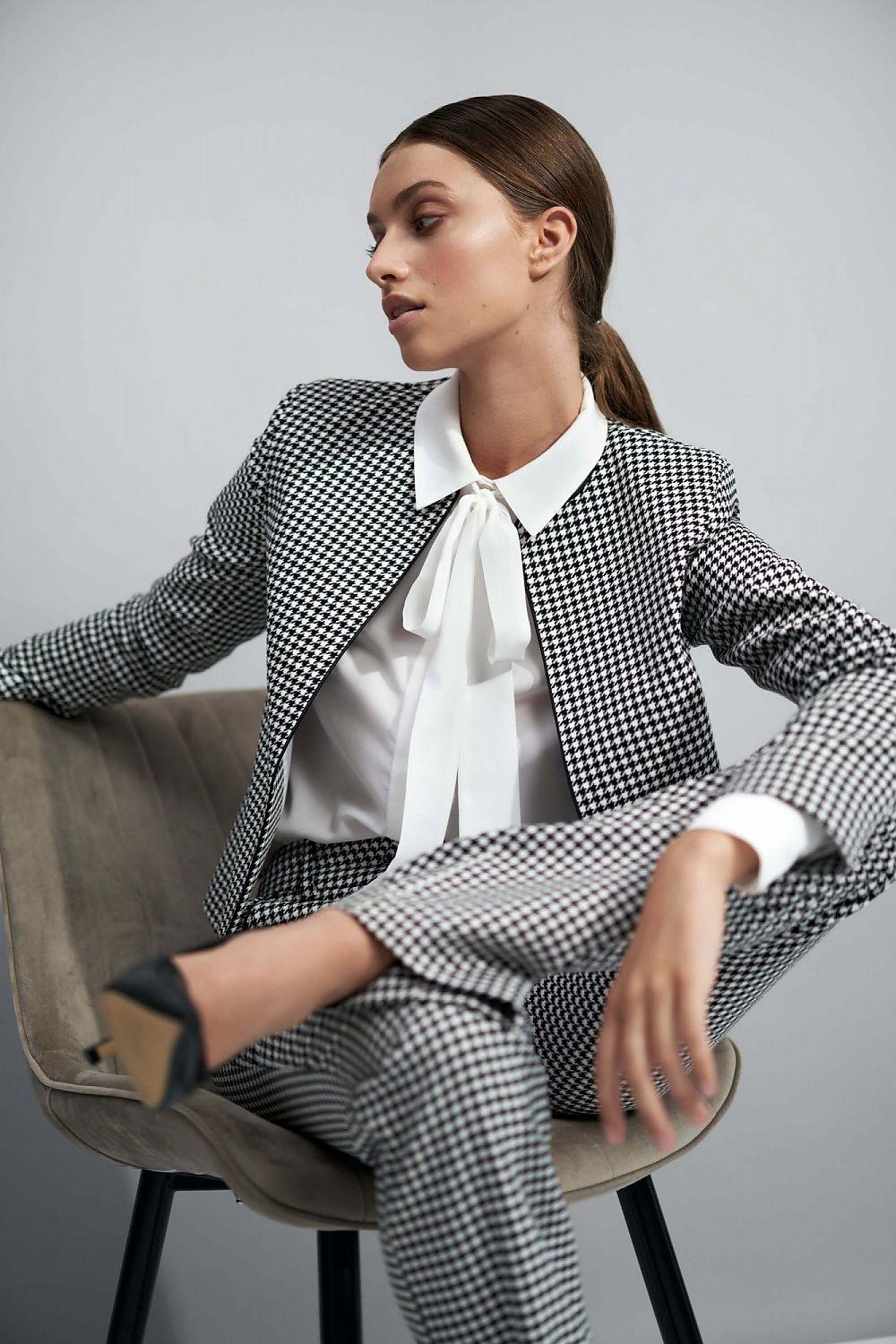 Black and white houndstooth women’s jacket with notched lapels and long sleeves