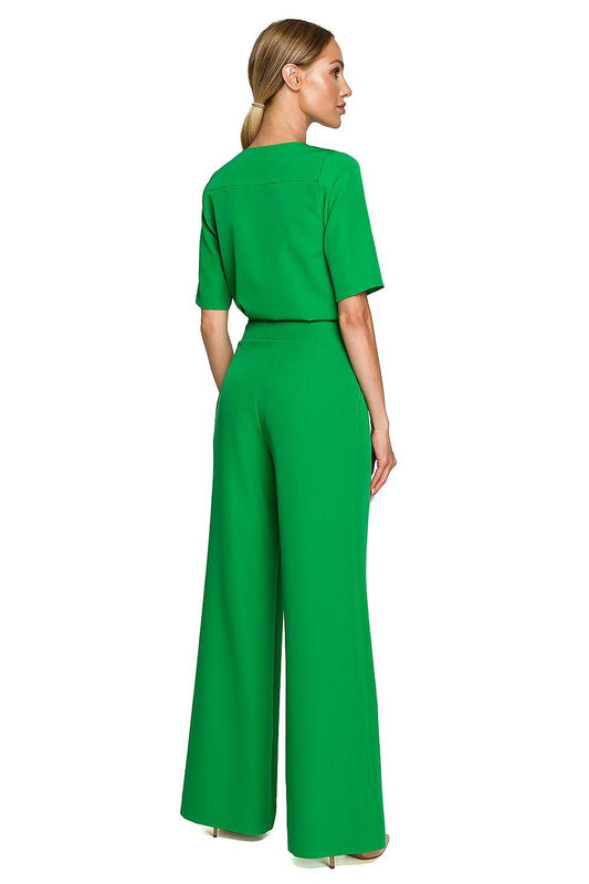 Green back view of V-neck top with short sleeves and wide-leg trousers, belted waist