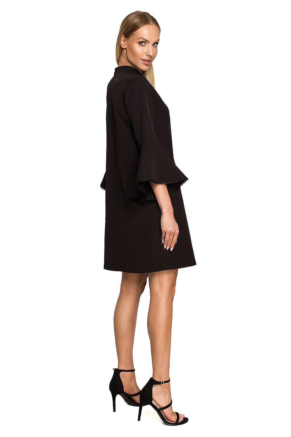 Black daydress side view with wide bell sleeves and scalloped hem trim