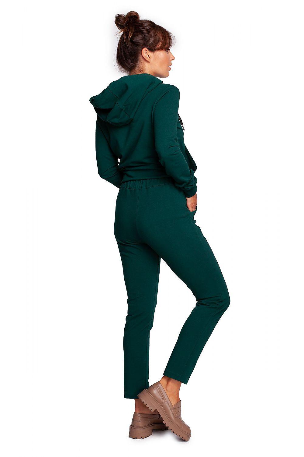 Women’s dark green tapered trousers, side view, with ankle cuffs and pockets