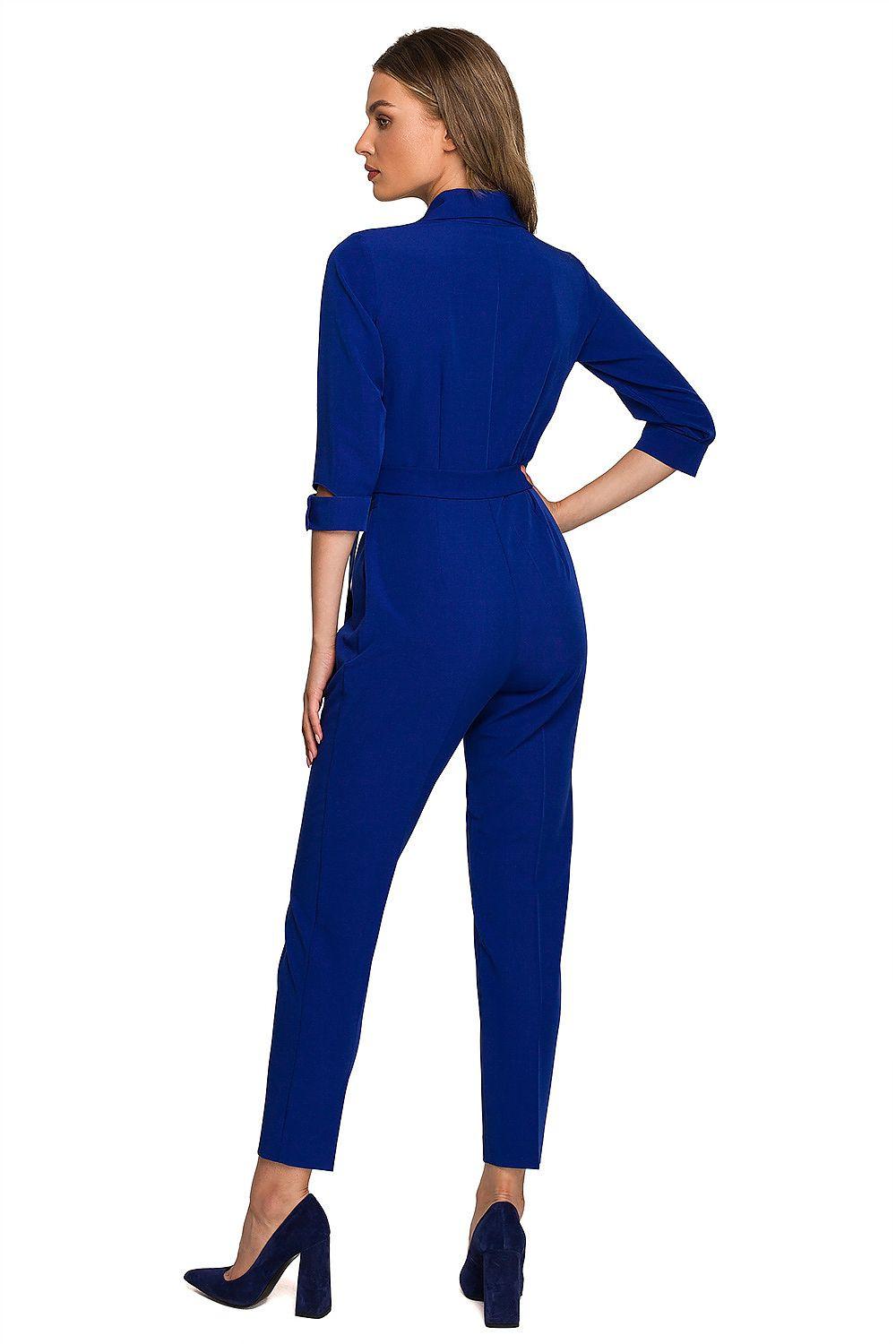 Blue belted jumpsuit side view with 3/4 sleeves and tapered ankle legs