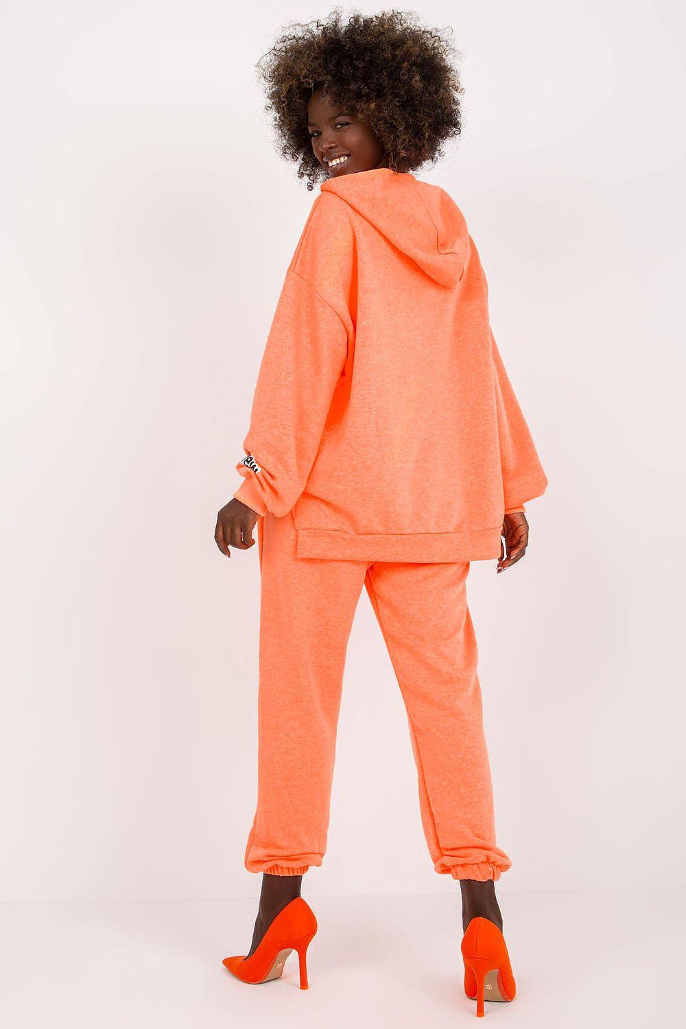Orange hoodie and jogger set with small logo details on back and cuff