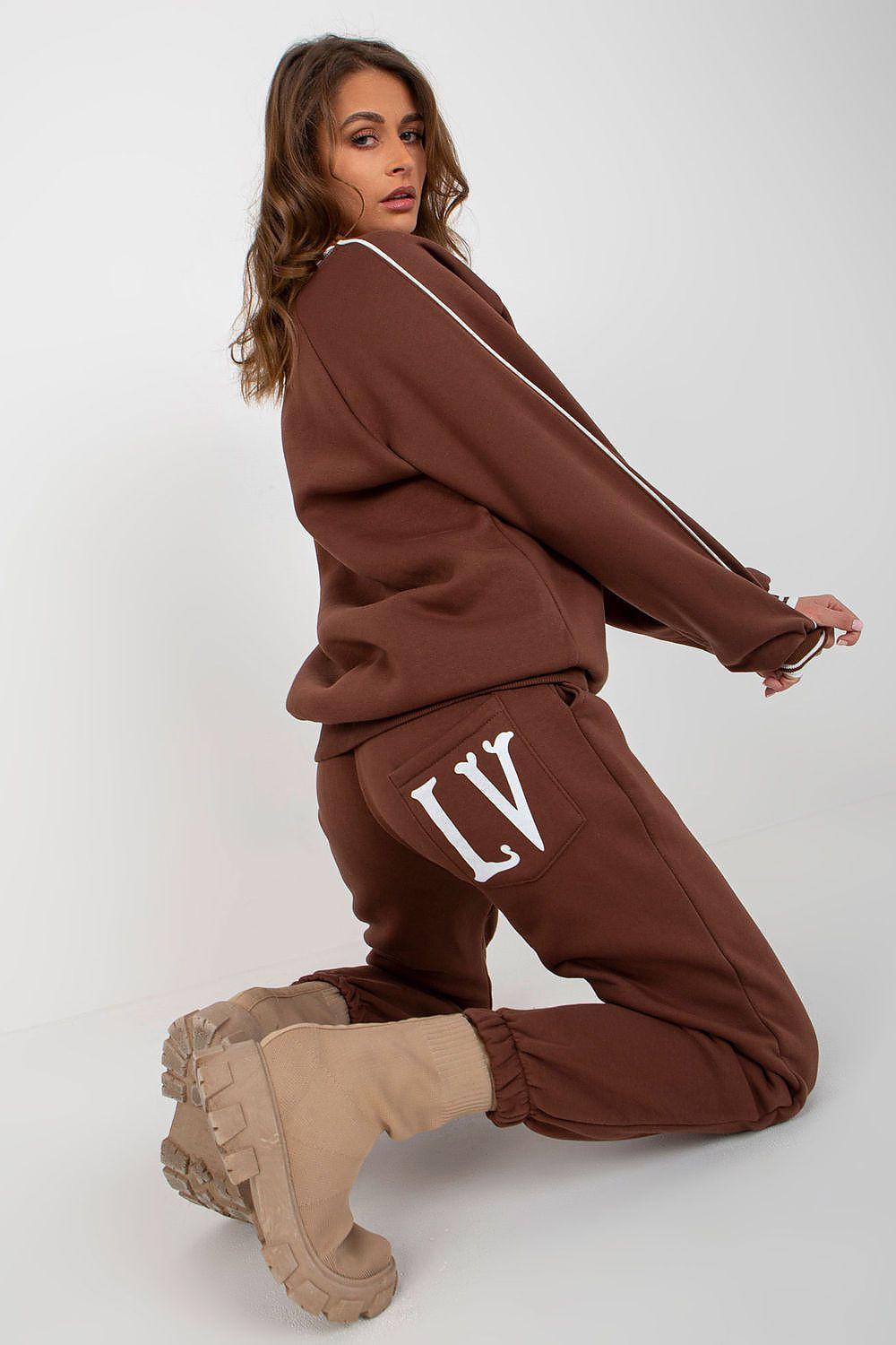 Brown jogger set with printed crewneck sweatshirt and drawstring joggers, kneeling view