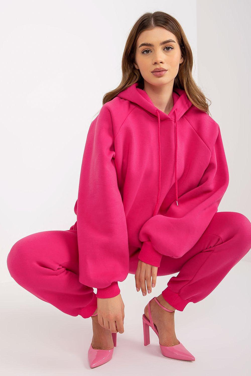 Pink two-piece hoodie and jogger set with drawstring waist and front kangaroo pocket