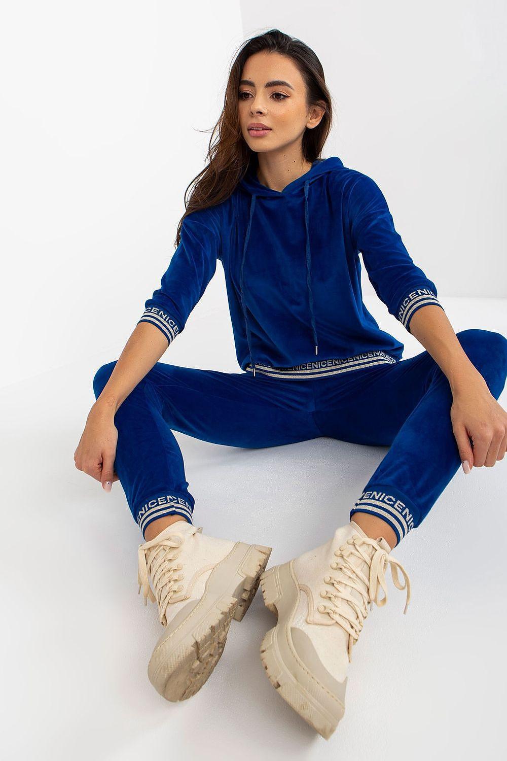 Blue zip hoodie and jogger set with hood, striped cuffs, and sneakers
