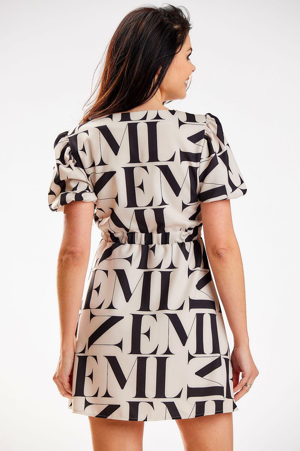 Beige daydress with black typographic print, back view, short sleeves, belted waist