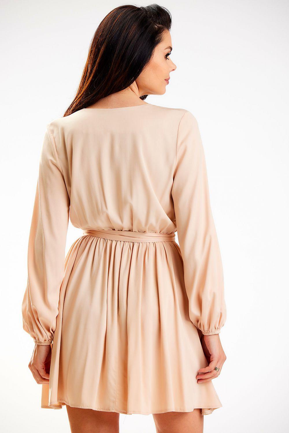 Beige daydress back view with gathered waist and long puff sleeves, pleated skirt