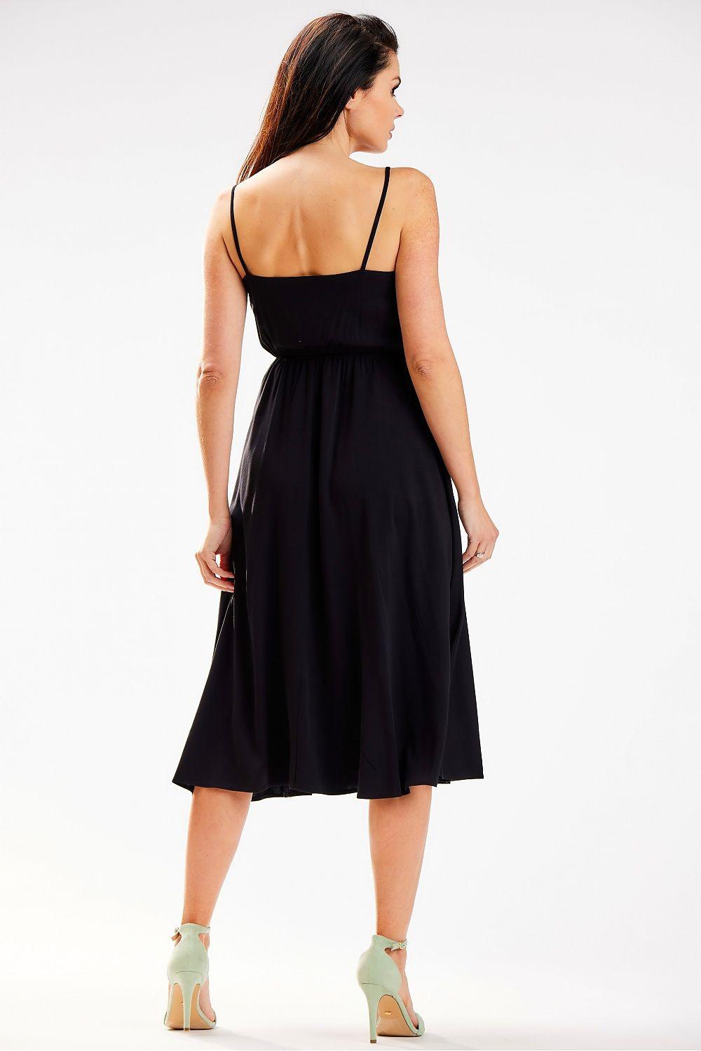 Black daydress with open back and thin straps, gathered waist, flared knee-length skirt