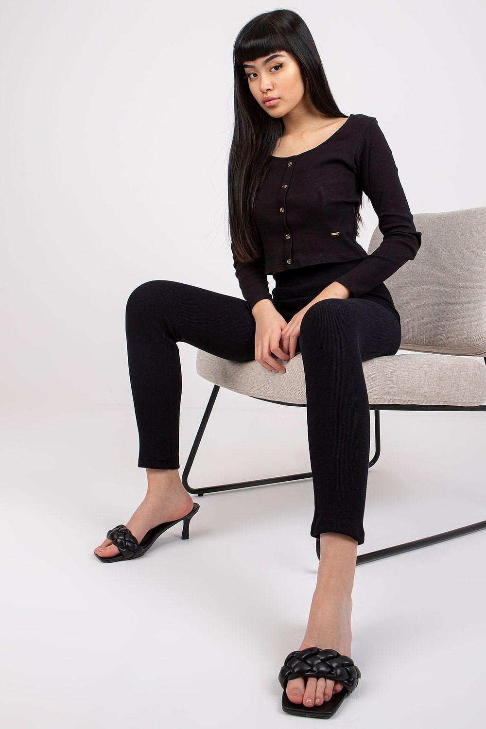 Black ribbed high-waist long leggings, seated view with slim ankle fit