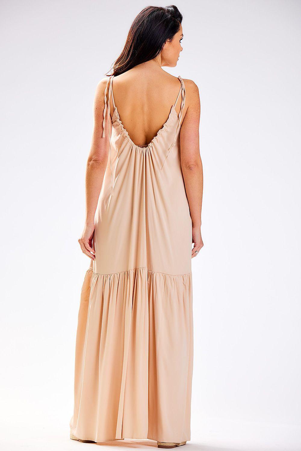 Beige sleeveless daydress with thin straps, open back, and tiered hem
