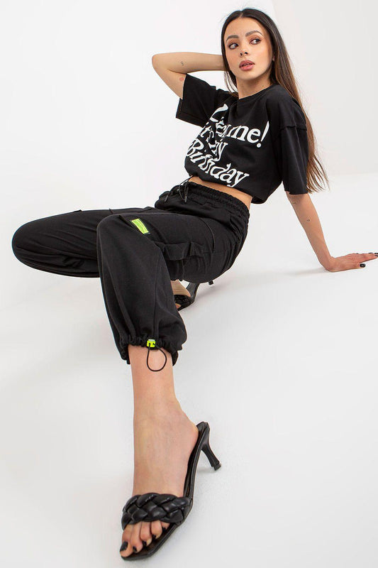 Black graphic cropped T-shirt and cargo jogger pants set, side view with pockets