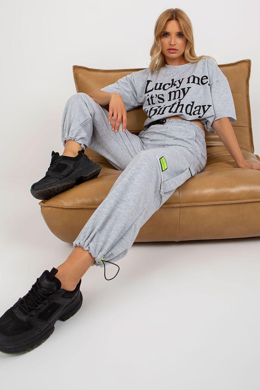 Grey graphic cropped T-shirt and cargo jogger pants set, lounging pose