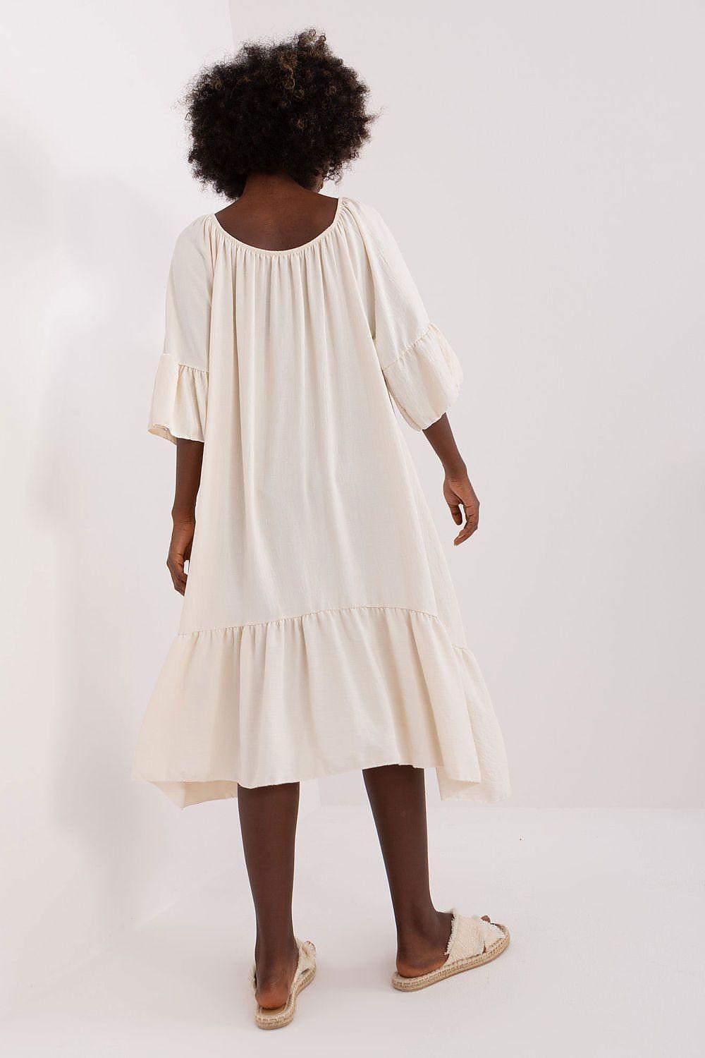 Beige daydress back view with round yoke, gathered tiered skirt hem